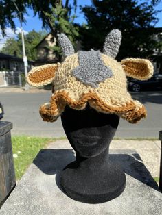 a crocheted hat with horns on top of a mannequin head