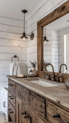 a bathroom with two sinks and a large mirror