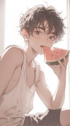 a young man is eating a piece of watermelon in front of a window