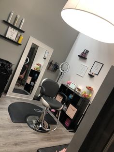 a salon chair sitting on top of a hard wood floor