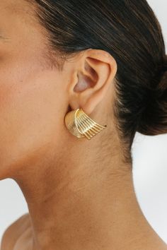 STYLE + FIT NOTES: Make a statement with the Carmine Layered Earring in gold. These unique earrings feature crossed lines for a chunky, standout look. Shine bright + add some edge to your style. Statement Gold Earrings, Unique Earrings, Shine Bright, Hair Jewelry, Your Style, Gold Earrings, Gold Color, Hair Accessories, Brass