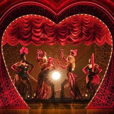 the dancers are performing on stage in front of a heart