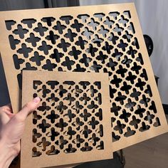 two pieces of wood cut out to look like crosses and hearts with holes in them