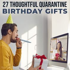 a man with a birthday hat is looking at a computer screen and holding a present