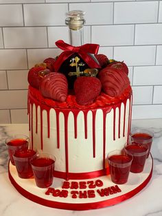 a cake decorated with strawberries and chocolate drizzles