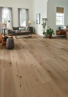 a living room filled with furniture and wooden floors