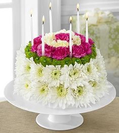 a cake with white and pink flowers on it