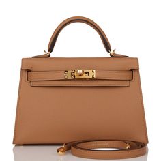 This tiny Kelly, in the Sellier style, is in Chai epsom leather with gold hardware and has tonal stitching, two front straps with front toggle closure, single rolled handle and removable shoulder strap.The interior is lined with Chai leather and has one open pocket on the back wall.Collection: UOrigin: FranceCondition: New (plastic on hardware)Accompanied by: Hermès box, Hermès dustbag, shoulder strap, shoulder strap dustbag, felt, carebookMeasurements:﻿ 7.5" width x 4.5" height x 2.2" depth; 2. Hermes Kelly Sellier, Kelly Sellier, Hermes Box, Handbag Wallet, Hermes Bags, Wallet Accessories, Tote Handbags, Gold Hardware, Luxury Bags