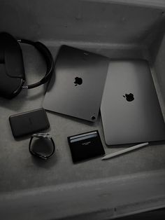 an apple laptop computer sitting on top of a table next to other electronics and accessories