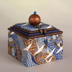 a decorative box with an ornament on top