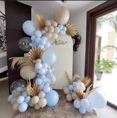 balloons and streamers are arranged in the shape of an arch for a birthday party