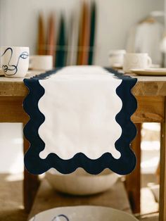 a white bowl sitting on top of a wooden table next to a blue and white place mat