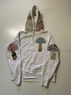 1 Of 1 Reworked Champion Reverse Weave VTG Quilted Patchwork Mushroom Hoodie Size LG. Sourced & Reworked @ Bluesin N' Crusin Vintage Measures approximately: Chest: 52 inches around (26 inches flat pit to pit) Shoulder to hem line: 29 inches All Items Shipped In Our One Of One Box Please Note That Items We're Made From Preloved Materials & Handmade So May Have Slight Discoloring Wear. Clothing To Promote Our Idea Of Sustainability & History Pieces May Have Small Imperfections (Light Spotting Etc.) Will Be Noted In Pictures. Thanks For Viewing & Have A Blessed One White Patchwork Sweatshirt For Streetwear, White Winter Hoodie With Patchwork, White Patchwork Hoodie For Winter, White Long Sleeve Hoodie With Patchwork, White Patchwork Hoodie, Patchwork Cotton Hoodie For Streetwear, Patchwork Tshirt Ideas, Cotton Patchwork Hoodie, Winter Cotton Sweatshirt With Patches