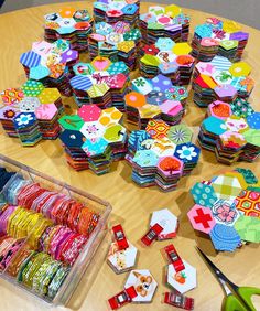 the table is covered with many colorful pieces of paper