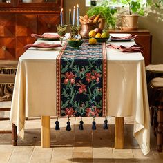 the table is set with fruit and candles