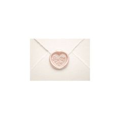 an envelope with a wax stamp on it and a heart in the middle that says love