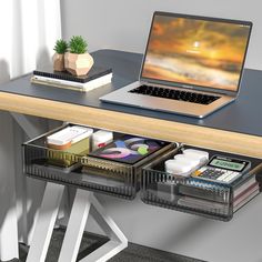 an open laptop computer sitting on top of a wooden desk next to a stack of files