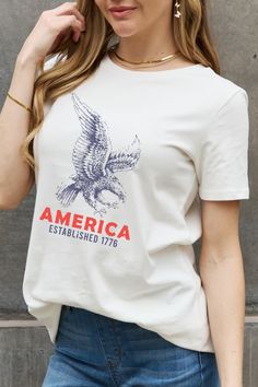 AMERICA ESTABLISHED 1776 Eagle Patriotic USA Graphic 100% Cotton T-Shirt This patriotic Americana-style classic t-shirt is ideal for the all-American woman with style !AMERICA ESTABLISHED 1776 on a solid white top featuring an American eagle graphic in large print.Short-sleeve breathable 100% cotton shirt.Comfortable, lightweight, slightly stretchy.Perfect for pairing with jeans, shorts, or leggings, especially for the 4th of July Independence Day holiday. Details: Color: White Sleeves: Short Ne Love America, Americana Fashion, Graphic Style, Shop Gift, Graphic Apparel, Type Graphic, Team Shirts, Basic Style, Cotton Shorts