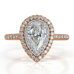 a pear shaped diamond ring set in rose gold