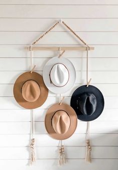 three hats are hanging on the wall