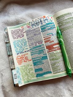 an open bible with writing on it and a green pen laying next to the page