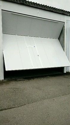 an open white garage door on the side of a building