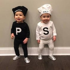 two toddlers dressed up as salt and pepper shakers standing next to each other