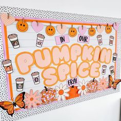 there is a sign that says pumpkin spice next to some flowers and butterflies on the wall