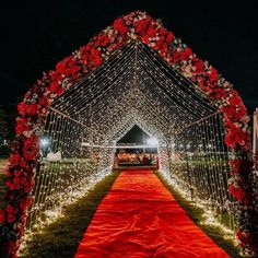 a red and white wedding aisle decorated with flowers