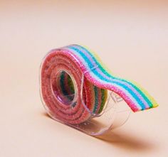 a roll of rainbow colored fabric sitting on top of a table