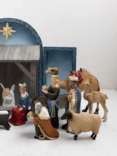 a nativity scene with figurines of people and animals