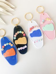 three key chains with different designs on them