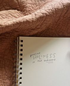 a notepad with writing on it sitting next to an open notebook that says, please homeless in the ordinary