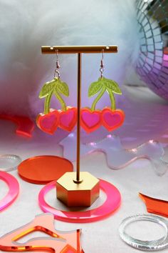 USA-made cherry heart earrings! Made of lightweight durable acrylic plastic and hypoallergenic sterling silver ear hooks. Choose from neon pink and green, or reflective pink. Condition: New. Personally designed, laser-cut, hand-assembled. Measurements: 2" x 1.5" Shipping: Item ships in 4-7 days Pink Sparkly, Acrylic Plastic, Ear Hook, Heart Earrings, Neon Pink, Pink And Green, Laser Cut, Cherry, Fashion Inspo