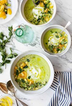 three bowls filled with soup on top of a table