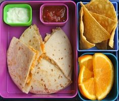 a lunch box with orange slices, tortilla chips and guacamole