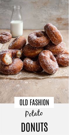 old fashion potato doughnuts on a table next to a bottle of milk with the words, old fashion potato donuts