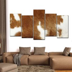 a brown and white cow print on a wall in a living room with couches