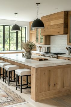 a large kitchen island with stools next to it