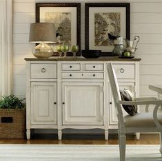 a white cabinet with two mirrors above it