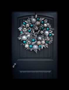 a black door with a wreath on it