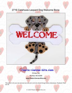 a cross stitch dog welcome sign with paw prints on it's chest and back