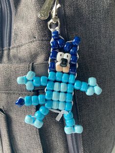 a keychain made out of legos is shown in the shape of a cartoon character