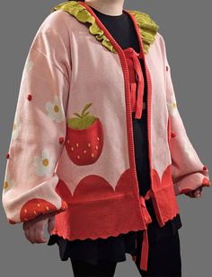 This cute and cozy cardigan is the perfect addition to any wardrobe! It features a bright red and pink colour scheme and adorable strawberry flower patterns adorned with fun small red accents along with green details to complete the strawberry aesthetic. The cardigan is super soft and comfortable, perfect for keeping you warm on a cool day. The strawberry decorations add a playful touch to the look, making it the perfect choice for a sweet, yet stylish look. Whether you're headed to a special ev Strawberry Blossom, Pink Colour Scheme, Strawberry Aesthetic, Whimsical Goth, Strawberry Flower, Strawberry Decorations, Green Details, Cozy Cardigan, Pink Colour