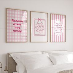 two framed pictures hang above a bed in a white bedroom with pink and white decor