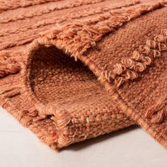 two pieces of brown knitted rugs laying on top of each other