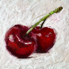 two cherries are shown on a white surface