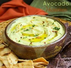 an image of a bowl of dip with chips on the side