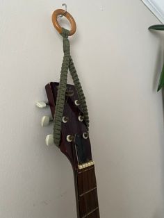 an acoustic guitar hanging on the wall