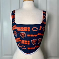 Over-bust corset with flexible boning and white cord lacing in back.  Chicago Bears cotton print.  There are no size options because these are made to order, so I will customize it to fit your measurements. Please dm me if you have any questions.  Mannequin's measurements - Waist: 27" Bust: 37" Sleeveless Cotton Corset With Fitted Bodice, Cotton Sleeveless Corset With Fitted Bodice, Cord Lace, Bear Ears, Corset Lingerie, Chicago Bears, Corsets, Dm Me, Halloween Shopping